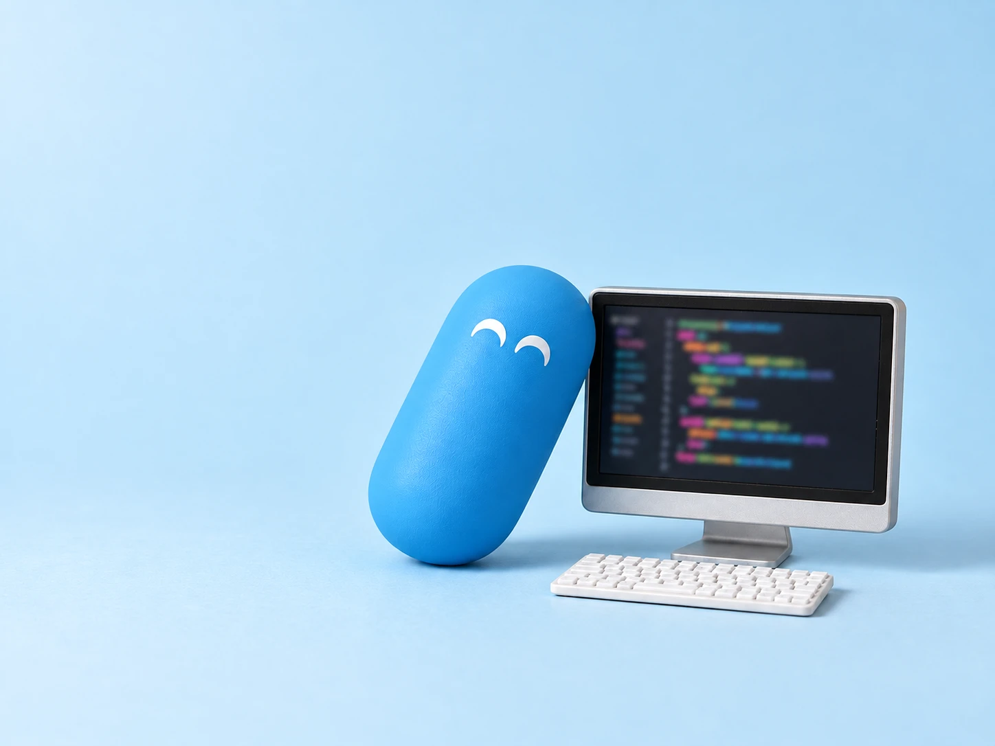 A happy light-blue pill leaning on a tiny monitor full of blurred, colorful code, with a small white keyboard.